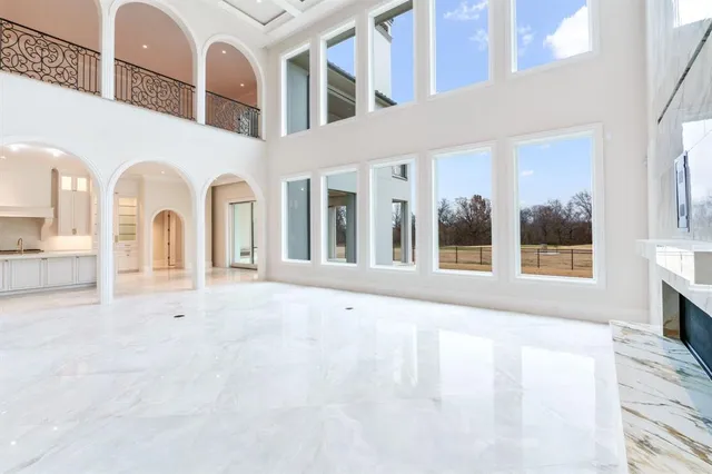 a view of an entryway with a floor to ceiling window and a kitchen