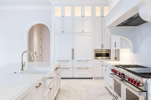 a kitchen with cabinets a sink and appliances