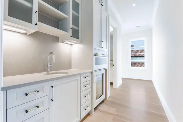 a kitchen with cabinets and window
