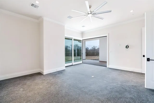an empty room with a ceiling fan and a window