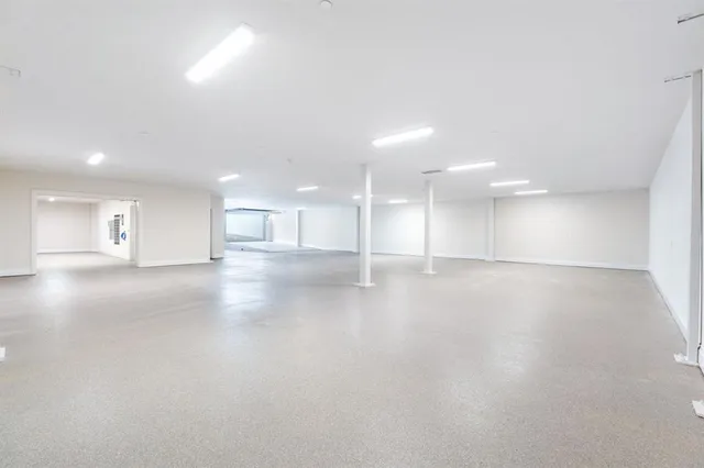 a view of an empty room with a kitchen