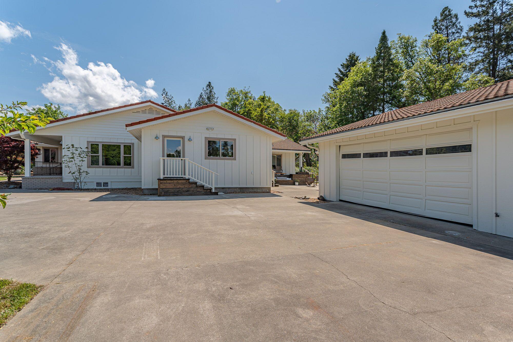 3134 South River Road Grants Pass, OR 97527 - Photo 32 of 38 a view of a house with a yard and garage