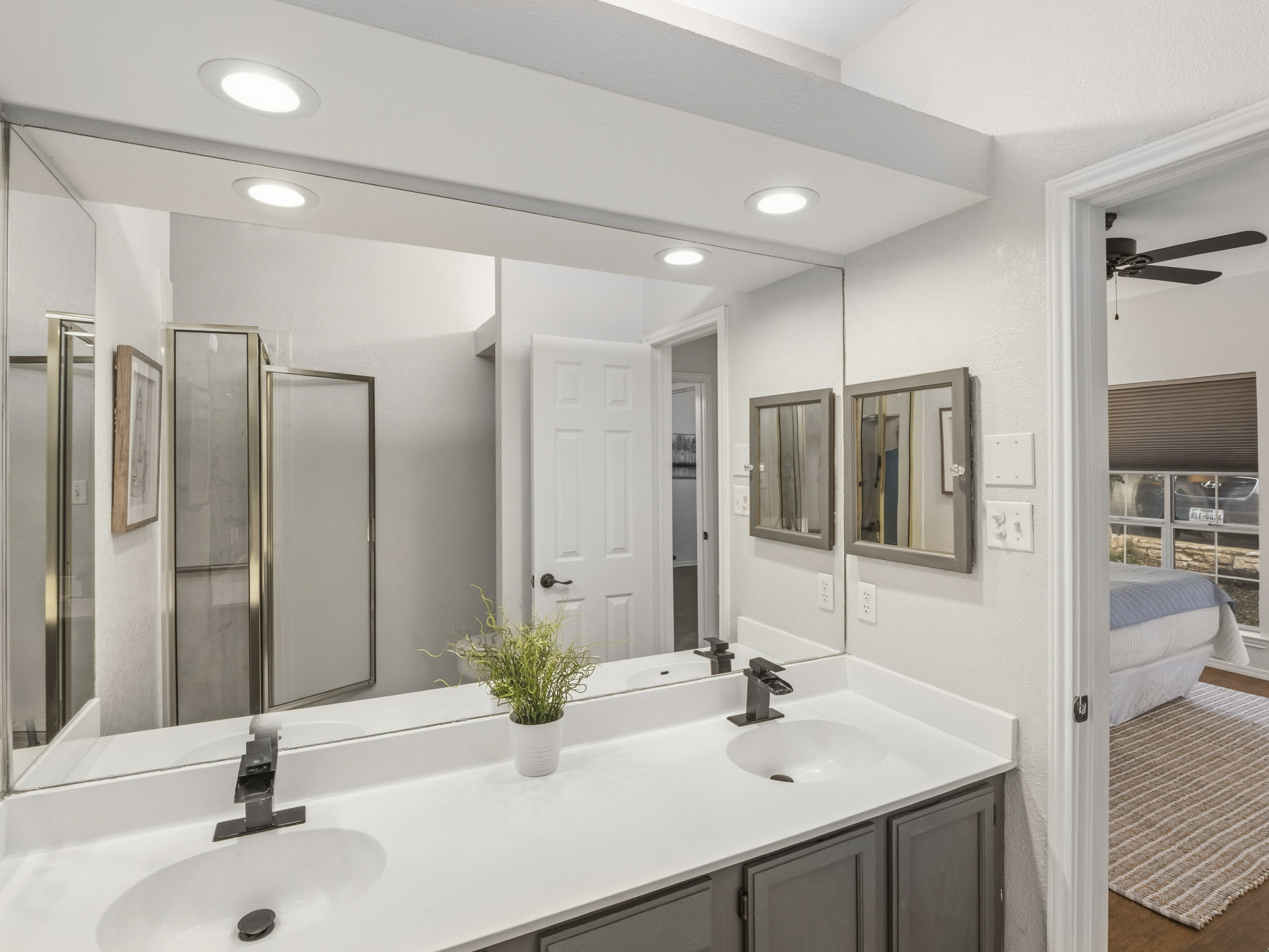 3809 Spicewood Springs Road, Unit 137 Austin, TX 78759 - Photo 13 of 34 Double vanities and recessed lighting elevate this well-appointed bathroom.