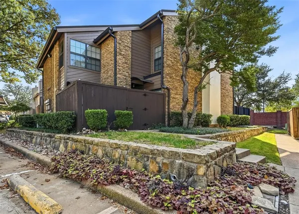 a view of a house with a yard and pathway