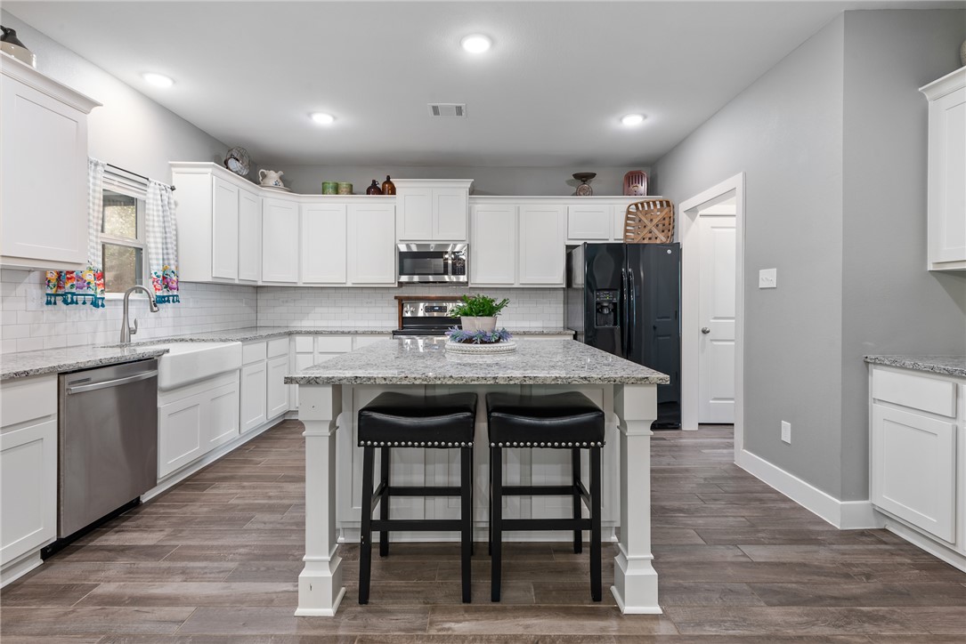 8729 Nathan Drive Waller, TX 77484 - Photo 14 of 48 Kitchen featuring appliances with stainless steel finishes, white cabinetry, and recessed lighting