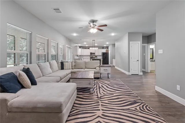 a living room with furniture and a chandelier
