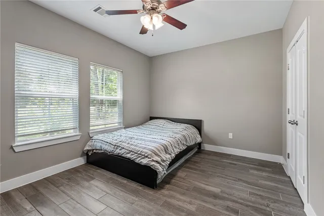 a spacious bedroom with a bed and a window