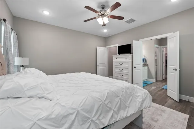 a bedroom with a large bed and a chandelier
