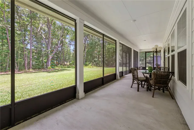 a view of a two room with furniture and floor to ceiling window