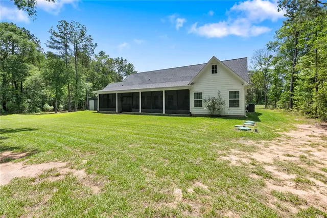 a view of a house with a yard and sitting area