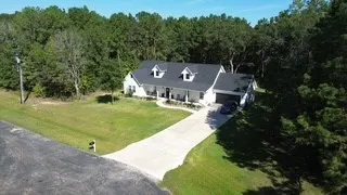a view of house with yard