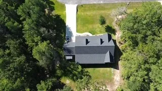 a view of a house with a yard and a garage