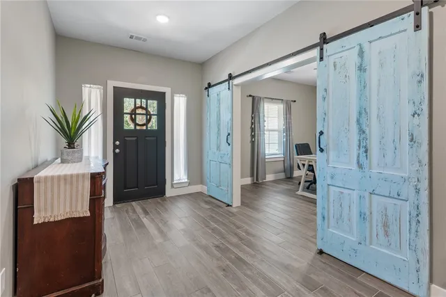 a view of hallway with wooden floor