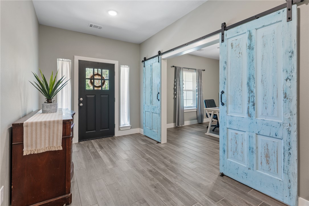 8729 Nathan Drive Waller, TX 77484 - Photo 6 of 48 Foyer with a barn door and wood finished floors