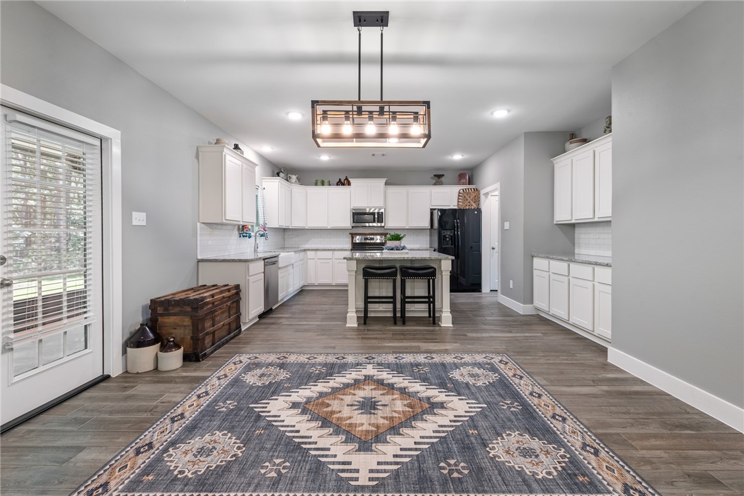 8729 Nathan Drive Waller, TX 77484 - Photo 9 of 48 Kitchen with appliances with stainless steel finishes, decorative backsplash, white cabinets, dark wood finished floors, and recessed lighting
