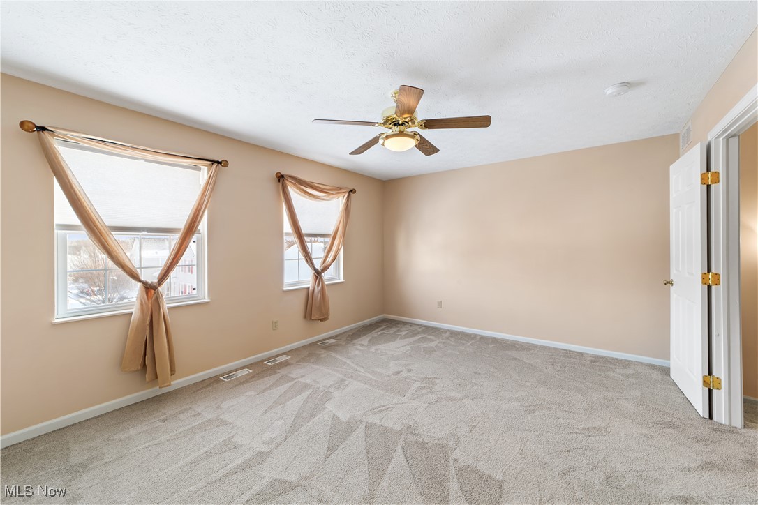 4364 Sexton Road Cleveland, OH 44105 - Photo 21 of 50 Unfurnished room with light colored carpet, a ceiling fan, and a textured ceiling