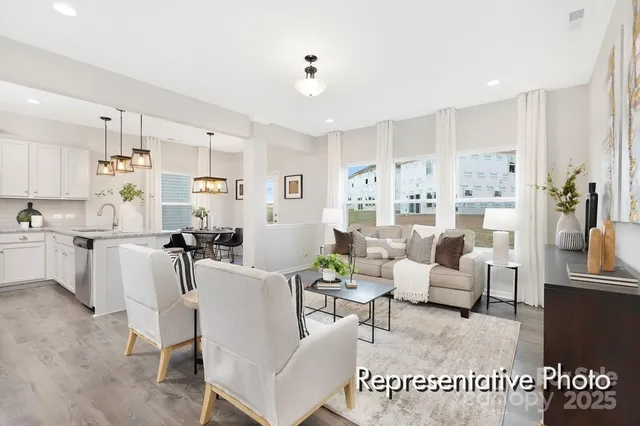 a living room with furniture white walls and white appliances