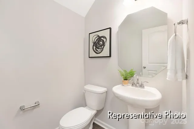 a bathroom with a toilet a sink and a mirror