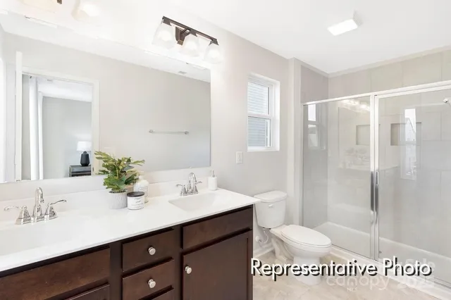 a bathroom with a sink a mirror a shower and a bathtub