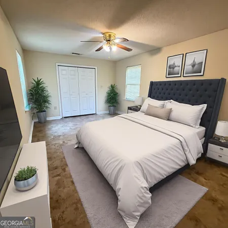 a bedroom with a bed and a potted plant