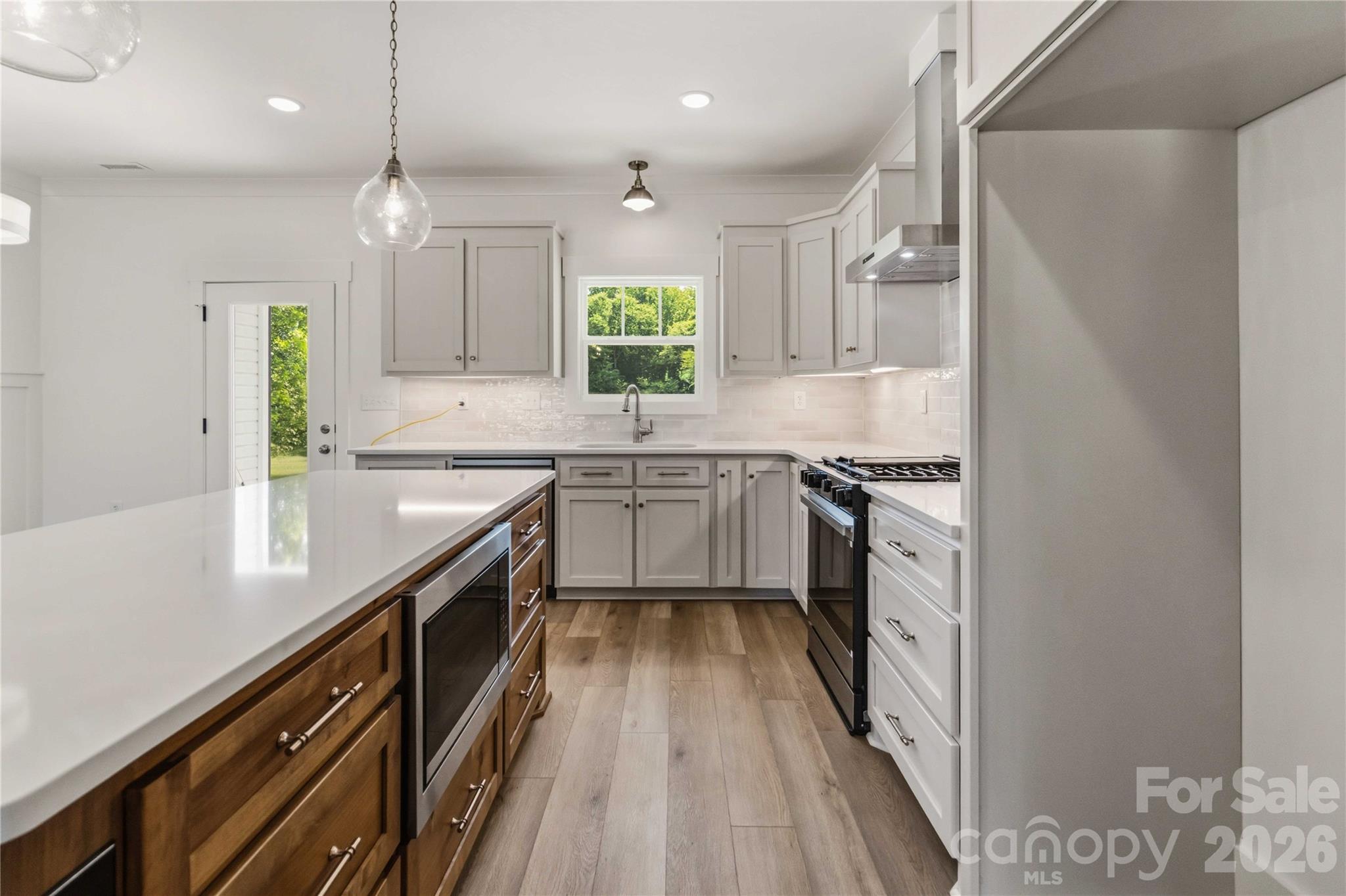 352 Adams Road Clover, SC 29710 - Photo 8 of 38 a kitchen with stainless steel appliances granite countertop sink a stove top oven a counter space and cabinets