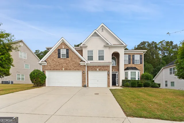 a front view of a house with a yard and garage