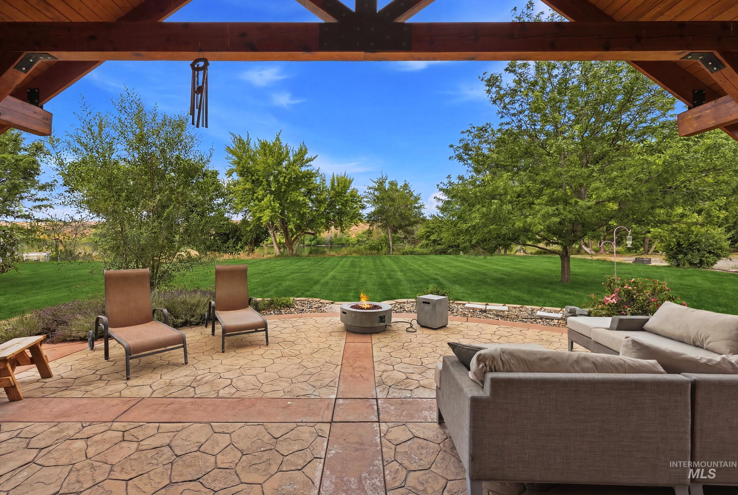 339 Airport Road Weiser, ID 83672 - Photo 30 of 49 Expansive outdoor patio featuring stamped concrete, a built-in fire pit, and stone retaining walls