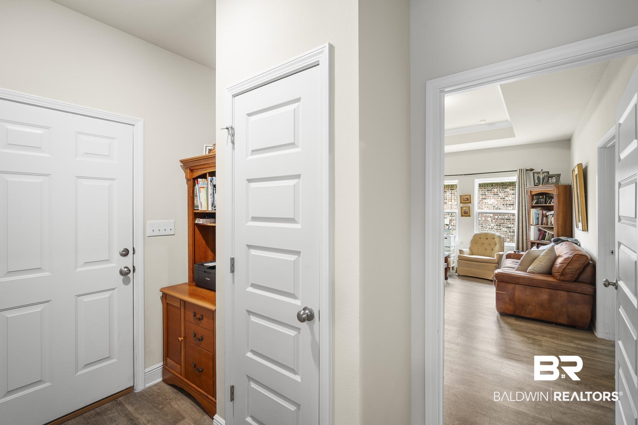 24765 Spectacular Bid Loop Daphne, AL 36526 - Photo 7 of 45 Hall with dark wood-type flooring and a raised ceiling