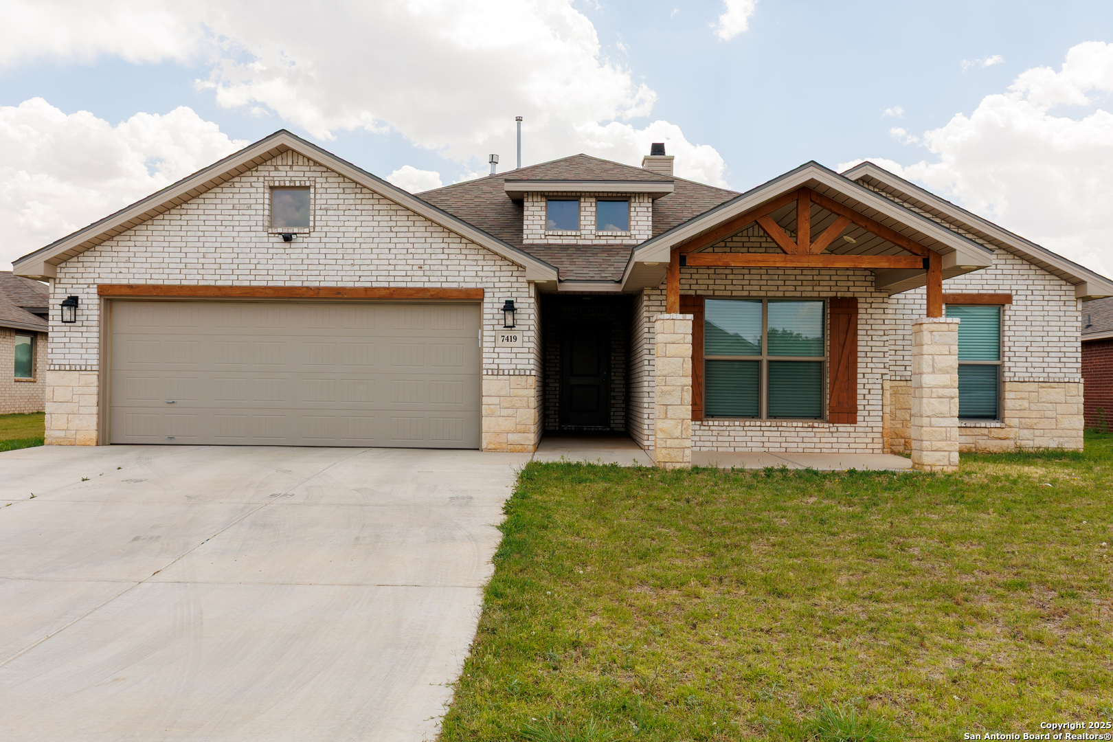 a front view of a house with a yard and garage