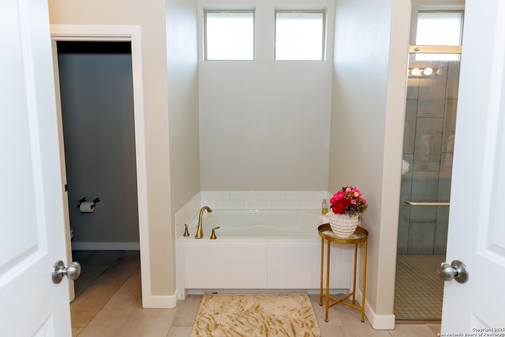 7419 29th Street Lubbock, TX 79407 - Photo 11 of 21 a bathroom with a bath tub and a shower