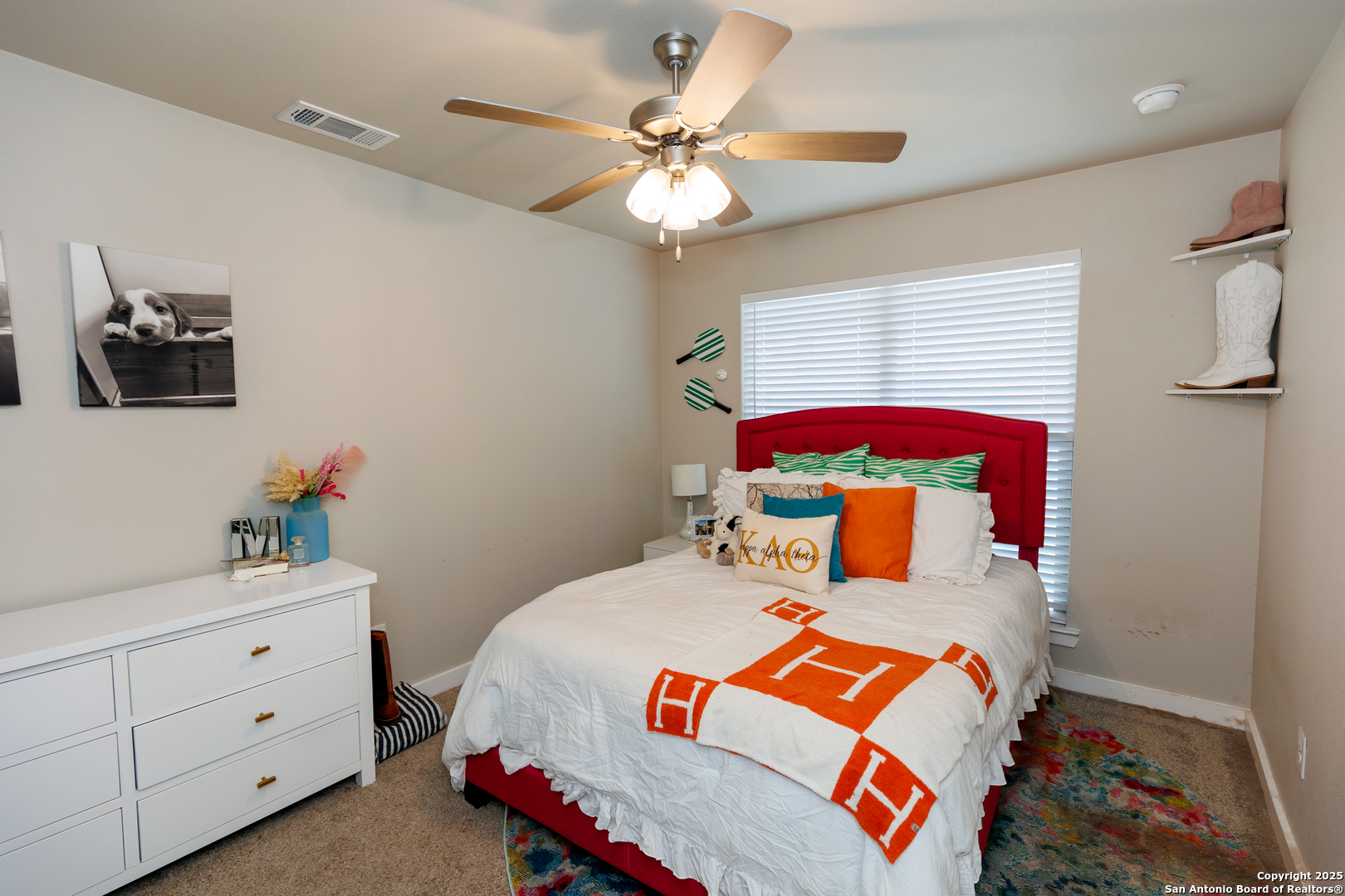 7419 29th Street Lubbock, TX 79407 - Photo 16 of 21 a bedroom with a bed and a chandelier
