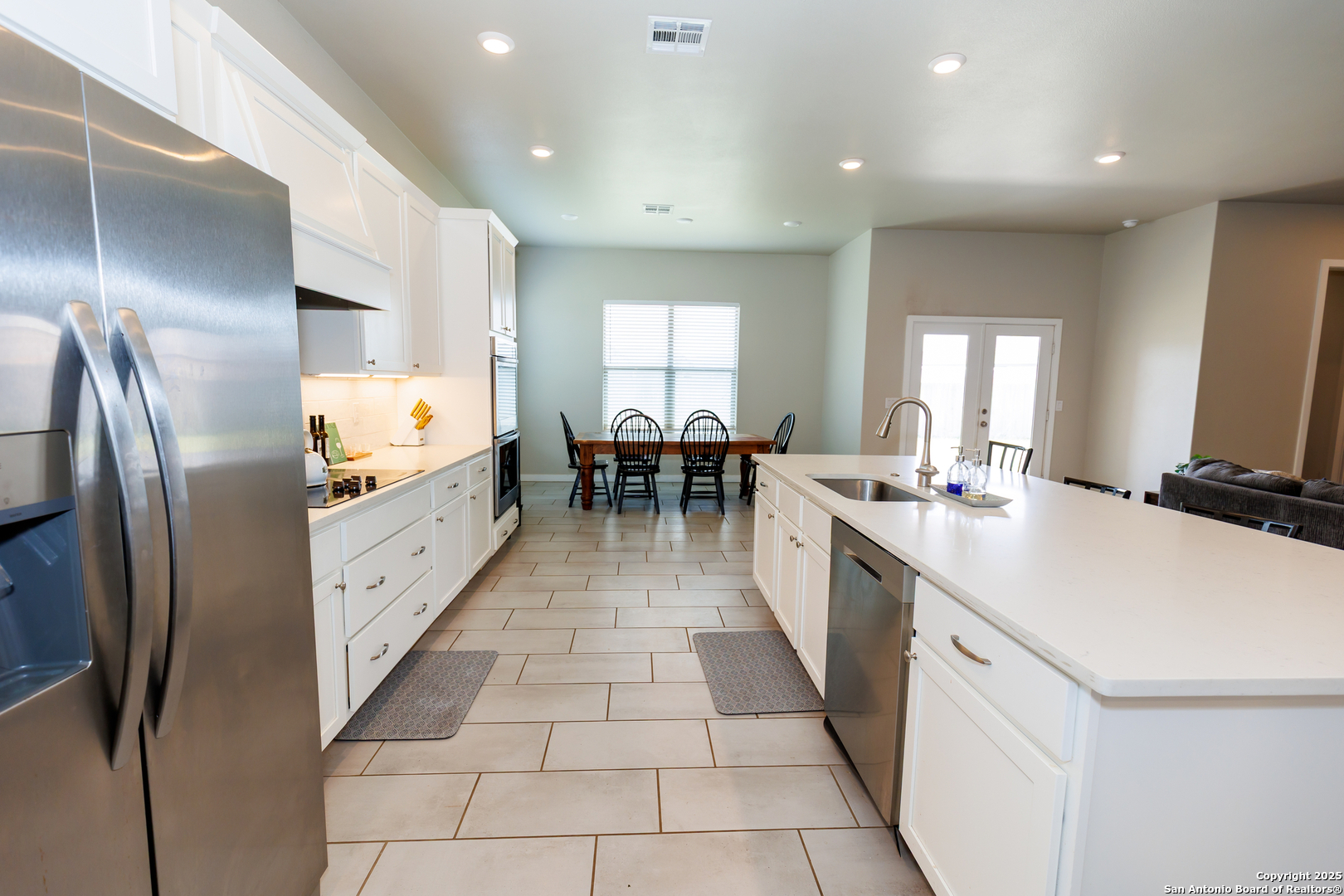 7419 29th Street Lubbock, TX 79407 - Photo 5 of 21 a large kitchen with kitchen island a sink counter space and stainless steel appliances