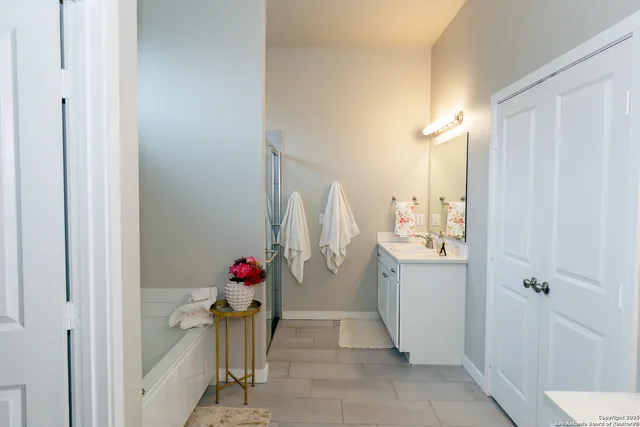 a bathroom with a shower and a sink