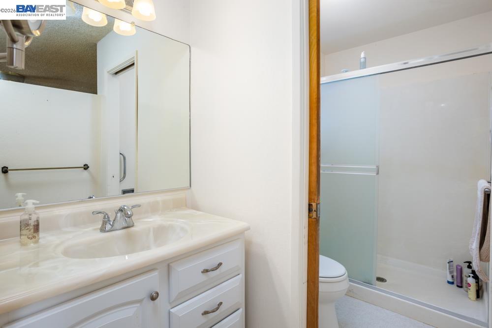 4591 Edwards Lane Castro Valley, CA 94546 - Photo 21 of 44 a bathroom with a granite countertop sink toilet and shower