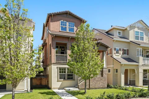 a front view of a residential apartment building with a yard