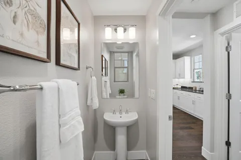 a bathroom with a sink a mirror and a toilet