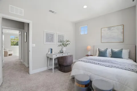 a bedroom with a bed and a table