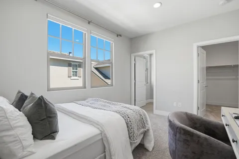 a bedroom with a bed couch and window