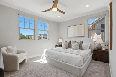 a bedroom with a bed couch and window