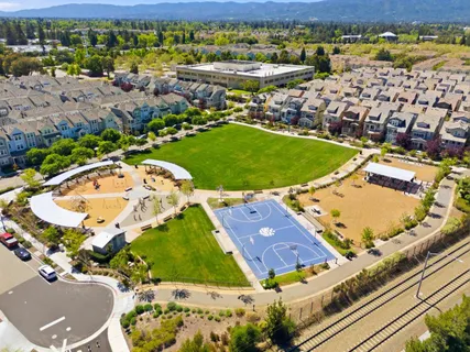 a view of a garden with a building in the background