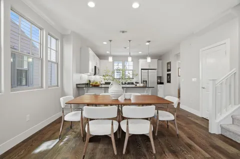 a dining room with furniture and a kitchen view
