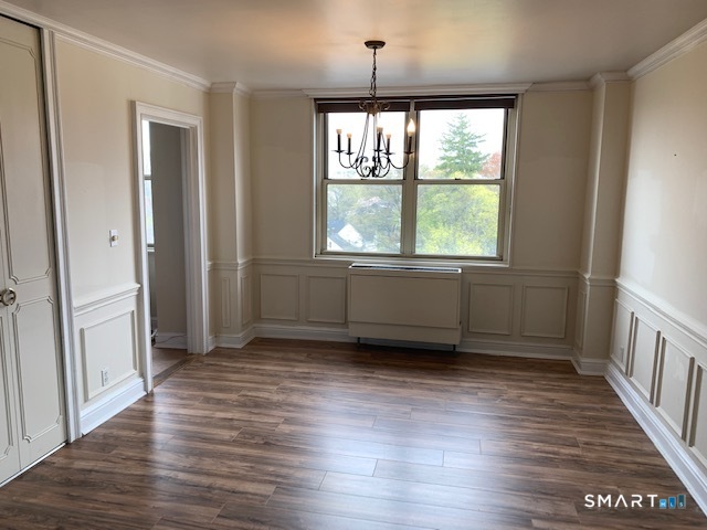 50 Glenbrook Road, Unit 5G Stamford, CT 06902 - Photo 38 of 40 an empty room with wooden floor and windows