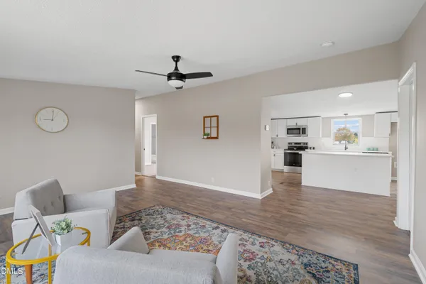 a living room with furniture and kitchen view