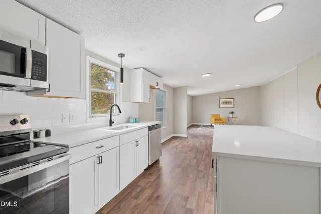 a kitchen with a sink stove and microwave