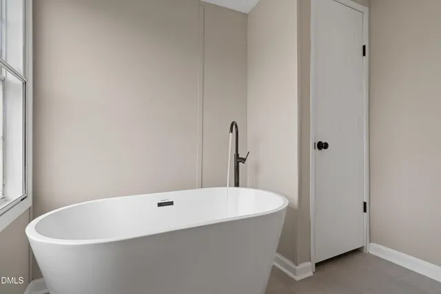 a white bath tub sitting in a bathroom