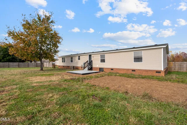 a view of a backyard with large trees