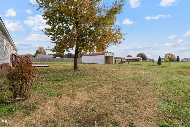 a backyard of a house with lots of green space