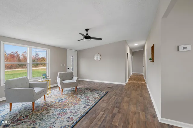 a living room with furniture and a floor to ceiling window