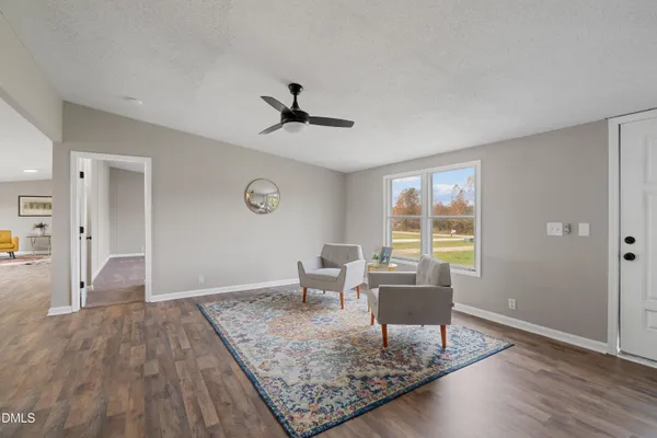 a living room with furniture and a wooden floor