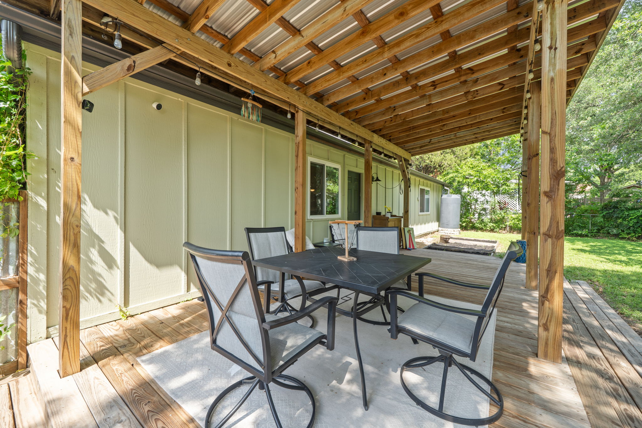 705 Dulwich Street Austin, TX 78748 - Photo 23 of 36 An inviting covered patio with a dining set extends the living space outdoors, perfect for alfresco meals.